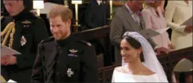  ?? UK POOL/SKY NEWS VIA AP ?? In this frame from video, Britain’s Prince Harry and Meghan Markle stand during their wedding ceremony at St. George’s Chapel in Windsor Castle in Windsor, near London.