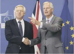  ??  ?? 0 Brexit Minister David Davis, left, with Michel Barnier