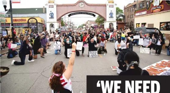  ?? ANTHONY VAZQUEZ/SUN-TIMES PHOTOS ?? Protesters kneel and observe a moment of silence for George Floyd during a protest on 26th St. in Little Village on Wednesday.