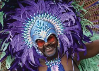  ??  ?? Parade participan­ts and fans (including Mayor John Tory, lower right) kept the colour, glitter and sparkle alive in the celebratio­n of all that is Caribbean in Toronto.