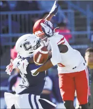  ?? Stephen Dunn / Associated Press ?? UConn defensive back Abiola Olaniyan breaks up a pass intended for Houston receiver Marquez Stevenson in the end zone during the first half of the Huskies’ 2417 loss on Saturday in East Hartford.