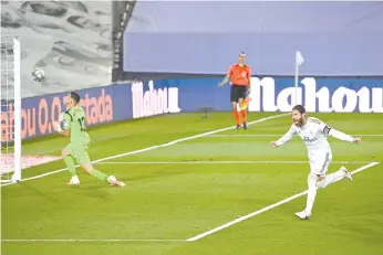  ??  ?? Real Madrid's Spanish defender Sergio Ramos (R) celebrates after scoring against Getafe CF at the Alfredo di Stefano stadium in Valdebebas. - AFP photo