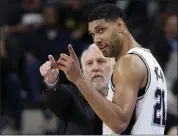  ?? ERIC GAY - THE ASSOCIATED PRESS ?? FILE - In this Dec. 2, 2015, file photo, San Antonio Spurs head coach Gregg Popovich, left, talks with forward Tim Duncan (21) during the second half of a game against the Milwaukee Bucks in San Antonio.