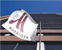  ?? REUTERS ?? A MARRIOTT FLAG hangs at the entrance of the New York Marriott Downtown hotel in Manhattan, New York, Nov. 16.