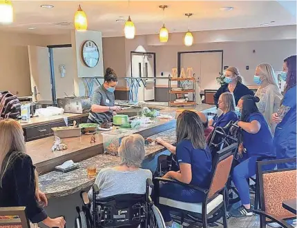  ?? ?? Staff and residents alike enjoy a celebratio­n at the Cearu Medical Resort, a short-term rehabilita­tion center located in Tulsa and owned by Diakonos Group. PROVIDED