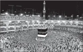  ?? AP/NARIMAN EL-MOFTY ?? Muslim pilgrims circle the Kaaba, Islam’s holiest shrine, at the Grand Mosque in the Muslim holy city of Mecca, Saudi Arabia, in September. Saudi Arabia, President Donald Trump’s first overseas stop, hosts millions of Muslim pilgrims annually at holy...