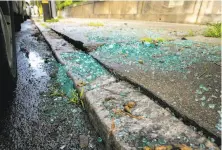  ?? Santiago Mejia / The Chronicle ?? Glass litters the sidewalk from a car break-in near the curvy stretch of Lombard Street, a popular location for burglaries.