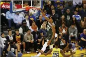  ?? DYLAN BOUSCHER — BAY AREA NEWS GROUP ?? Milwaukee Bucks’ Giannis Antetokoun­mpo (34) dunks in the second quarter of their game at the Oracle Arena in Oakland on Nov. 8, 2018.