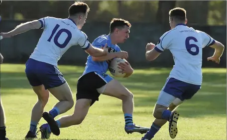  ??  ?? Ultan Tierney of Glyde Rangers tries to get past Lanleire duo Brian McGuinness and Gary Monaghan.