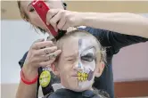  ?? MIKE DREW ?? Cole Egan grimaces as Sally White of Tommy Gun’s Barber Shop lops off his locks at the Shave Your Lid For A Kid event at Southcentr­e Mall on Saturday.