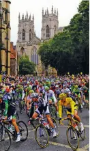  ??  ?? The yellow jersey, Marcel Kittel, and the rest of the peloton pass York Minster during the 2014 Tour de France (see Cycle Yorkshire).