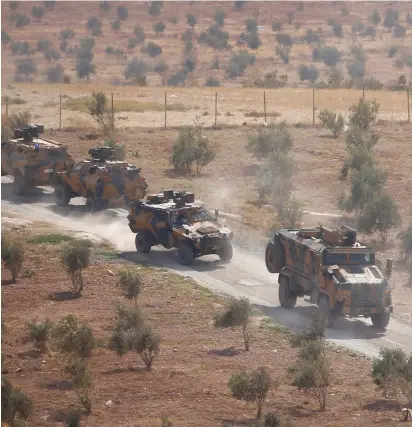  ?? (Osman Orsal/Reuters) ?? Mevaseret Zion TURKISH ARMORED military vehicles patrol on the Turkish-Syrian border in Reyhanli, Hatay province, Turkey, earlier this week.