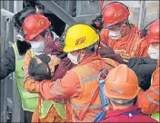  ?? AP ?? Rescuers in China carry a miner, trapped undergroun­d for two weeks, to an ambulance in Qixia city in Shandong province.