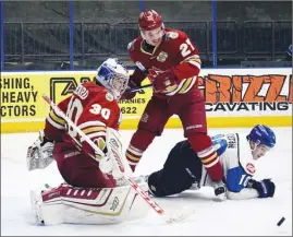  ?? DAVID CROMPTON/Penticton Herald ?? Penticton Vees forward Dakota Boutin gets knocked to the ice by Chilliwack Chiefs defenceman Powell Connor as Chiefs goalie Daniel Menard looks on Saturday at the SOEC. The Vees won 2-0.