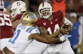  ?? SCOT TUCKER — THE ASSOCIATED PRESS ?? UCLA defensive lineman Gabriel Murphy tackles Cardinal quarterbac­k Ashton Daniels for one of his two sacks on Saturday at Stanford. Daniels was sacked four times in the game.