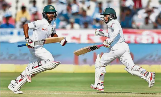  ?? — AP ?? Keep on going: Bangladesh captain Mushfiqur Rahim (right) and Mehedi Hasan run between the wickets during the third day of the Test match against India in Hyderabad yesterday.