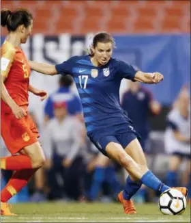  ?? RON SCHWANE — ASSOCIATED PRESS ?? The United States’ Tobin Heath passes around China’s Wu Haiyan during the second half of an internatio­nal friendly June 12 in Cleveland. The U.S. won, 2-1.