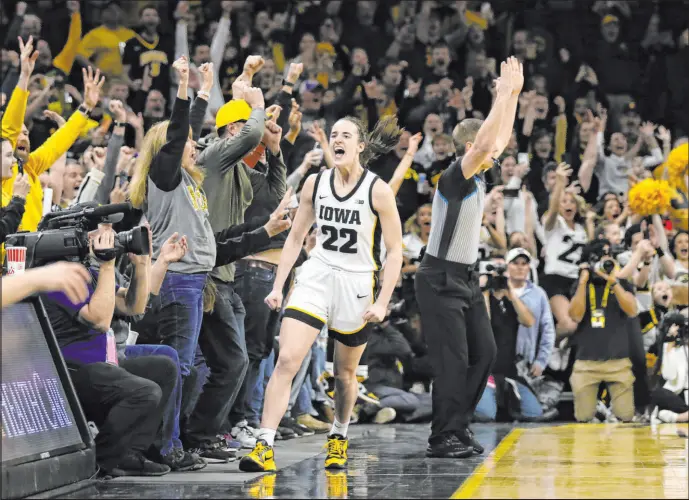  ?? Matthew Holst Getty Images ?? Iowa’s Caitlin Clark finished her collegiate career with 548 3-pointers, a shot not available when Lynette Woodard was setting scoring records four decades earlier.