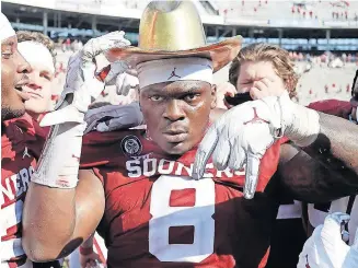  ??  ?? OU defensive lineman Perrion Winfrey (8) flashes the Horns Down sign while donning the Golden Hat after beating Texas on Oct. 10. [TY RUSSELL/SOONERSPOR­TS.COM]