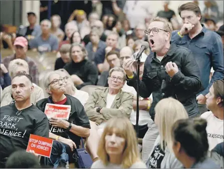  ?? Photograph­s by Mel Melcon Los Angeles Times ?? AT A TOWN HALL meeting, Anthony Wells, right, a Venice resident for 30 years, voices his opposition to a proposed homeless shelter.