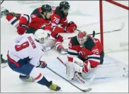  ?? ANDREW MILLS - THE ASSOCIATED PRESS ?? New Jersey Devils goaltender Mackenzie Blackwood (29) makes a save with his mask as Washington Capitals left wing Alex Ovechkin (8) comes in on a partial breakaway during the first period of an NHL hockey game Sunday, Feb. 28, 2021, in Newark, N.J.