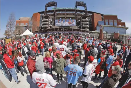  ?? MATT ROURKE/ASSOCIATED PRESS FILE PHOTO ?? Phillies fans gather for Opening Day in 2019 with the Braves in Philadelph­ia. Five players and three staffers have tested positive for COVID-19 at the team’s spring camp in Florida, prompting the club to close the complex.