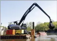  ?? MIKE GROLL — THE ASSOCIATED PRESS FILE ?? In this file photo, crews perform dredging work along the upper Hudson River in Waterford, N.Y. Dredging operations on the upper Hudson River have wound down after six years and some $1.5billion in costs, but the push to expand the cleanup continues.