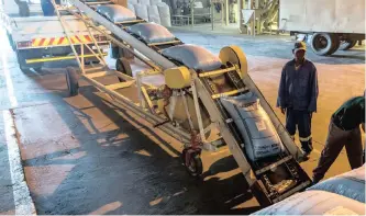  ?? DWAYNE SENIOR Bloomberg ?? EMPLOYEES load sacks of yellow maize on to a truck for shipping at the Kaap Agri grain silo in Malmesbury, Western Cape. South Africa’s maize supply is secured for the coming year. |