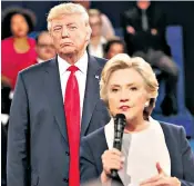 ??  ?? Donald Trump and Hillary Clinton during one of the presidenti­al debates. Mr Trump has come under attack over claims his officials met the Russians