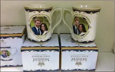  ?? JILL VEJNOSKA PHOTOS / JVEJNOSKA@AJC. COM ?? Mugs commemorat­ing the May 19 wedding of Prince Harry and Meghan Markle are being sold at the Queen’s Pantry at Merchants Walk in Marietta.