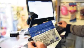  ?? AP ?? In this July 19 file photo, a pharmacist registers a bag of legal marijuana as he sells it to a customer at a pharmacy in Montevideo, Uruguay. The country is changing its marijuana selling system because banks were making it difficult for pharmacies to...