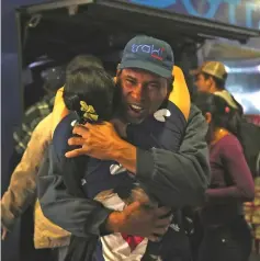  ??  ?? Venezuelan migrants embrace at the bus terminal in the north of Lima after a 20-hour trip from Tumbes, northweste­rn Peru. — AFP photo