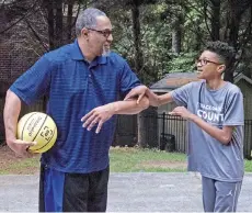  ??  ?? Kenneth Braswell plays basketball with his son in their driveway. — The Washington Post photo by Joshua Rashaad