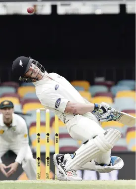  ??  ?? BRISBANE: New Zealand’s batsman James Neesham avoids a rising ball off Australia’s paceman Mitchell Johnson during the fifth and the final day of the first Test cricket match between Australia and New Zealand in Brisbane yesterday. — AFP