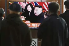  ??  ?? Important briefing: People watching a TV screen showing a file footage of Kim during a news programme at the Seoul Railway Station. — AP