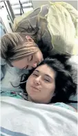  ?? HANDOUT/ THE CANADIAN PRESS ?? Samantha Mongeon, left, kisses her sister Sabryna, who had her arms and legs amputated following a car crash. Mongeon has undergone another surgery in Montreal.