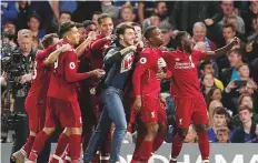  ?? Reuters ?? Liverpool’s Daniel Sturridge celebrates scoring their first goal with teammates against Chelsea at Stamford Bridge.