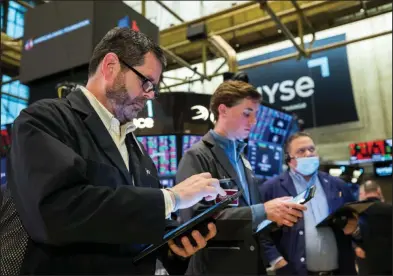  ?? (AP/NYSE) ?? Traders work Friday on the floor at the New York Stock Exchange.