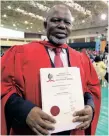  ?? | ABHI INDRARAJAN UKZN ?? DELANI Mthembu with certificat­ion confirming his PHD.