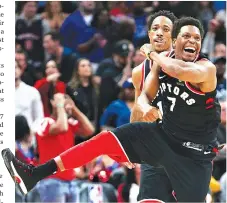  ??  ?? TORONTO RAPTORS guard Kyle Lowry (#7) celebrates a bases by guard DeMar DeRozan (back) in the second half against the Detroit Pistons at Little Caesars Arena.