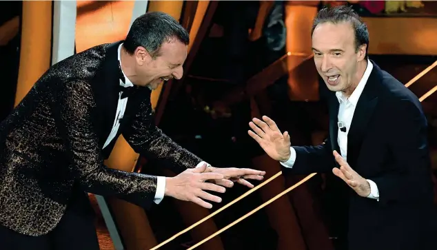  ??  ?? 2020
Roberto Benigni, 67 anni, ieri sera sul palco dell’ariston ha accennato a un tentativo di palpare Amadeus, ripetendo la famosa gag di cui fu «vittima» Pippo Baudo a Sanremo 2002. «Siamo nella serata delle cover, possiamo anche ripetere», ha detto l’attore e regista Premio Oscar