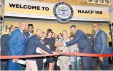  ?? ALGERINA PERNA/BALTIMORE SUN ?? Mayor Catherine Pugh, center, and Leon W. Russell, in gray suit, chairman of the NAACP board of directors, open the national convention.