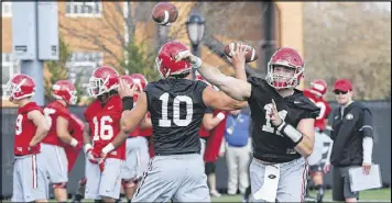  ?? CURTIS COMPTON / CCOMPTON@AJC.COM ?? Georgia quarterbac­ks Jacob Eason (10) and early-enrollee Jake Fromm throw passes on the first day of spring practice Tuesday.