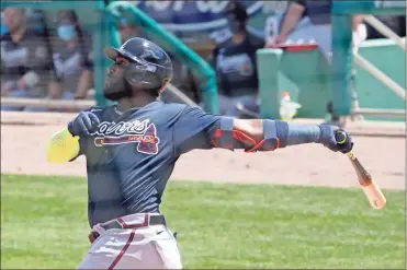  ?? AP-John Bazemore ?? Atlanta Braves left fielder Marcell Ozuna follows through on a three-run home run in the third inning of a spring training game against the Boston Red Sox on Tuesday in Fort Myers, Fla.