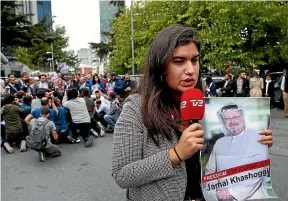  ?? AP, GETTY ?? A journalist, holding a poster of missing Saudi writer Jamal Khashoggi, speaks to the media near the Saudi Arabia consulate in Istanbul last week. Khashoggi, an outspoken critic of the Saudi Government, was last seen entering the consulate, below, on October 2.