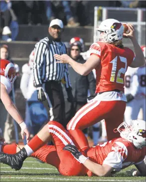  ?? H John Voorhees III / Hearst Connecticu­t Media ?? Greenwich quarterbac­k Gavin Muir throws a pass against New Canaan in the Class LL state championsh­ip game on Saturday at Boyle Stadium in Stamford. Greenwich won, 34-0, to complete an unbeaten season and win its first state title since 2007.