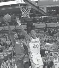  ?? JASEN VINLOVE/USA TODAY SPORTS ?? Heat guard Victor Oladipo shoots over Hawks forward John Collins during the first half on Tuesday in Miami.