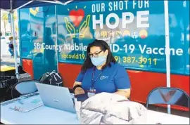  ?? Anna Almendrala Kaiser Health News ?? NANCY GARCIA, a San Bernardino County employee who lost her mother and a cousin to COVID-19, manages a pop-up vaccinatio­n clinic. There are few takers.