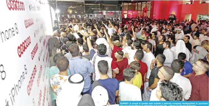  ?? —Photo by Yasser Al-Zayyat ?? KUWAIT: A crowd of people wait outside a telecom company headquarte­rs to purchase the new Apple iPhone 8 yesterday in Kuwait City.