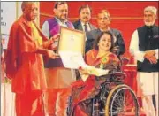  ?? DEEPAK GUPTA/HT ?? ▪ Chief minister Yogi Adityanath felicitati­ng a divyang at a state level prize distributi­on programme in Lucknow on Sunday.